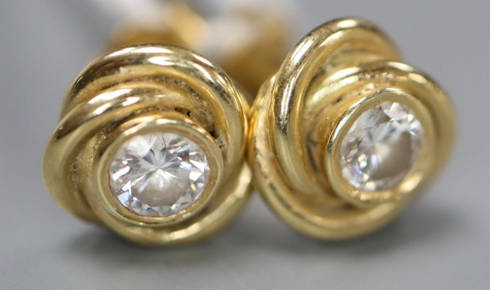 A pair of modern 750 yellow metal and solitaire diamond set knot ear studs, 8mm, gross 3.8 grams.